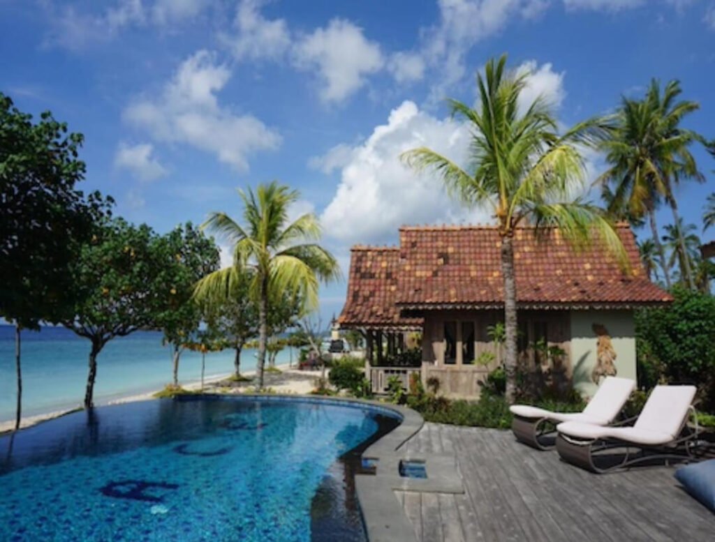 Poolside stunning views at a budget beachfront spot in Bali, kinda messy like my trips