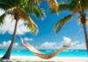 Tropical Beaches to Escape the Cold This Winter Hammock and abandoned winter hat on tropical beach