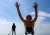 Top Paddle Boarding Beaches for Beginners and Pros Flailing belly-flop view of pro paddleboarder silhouette.