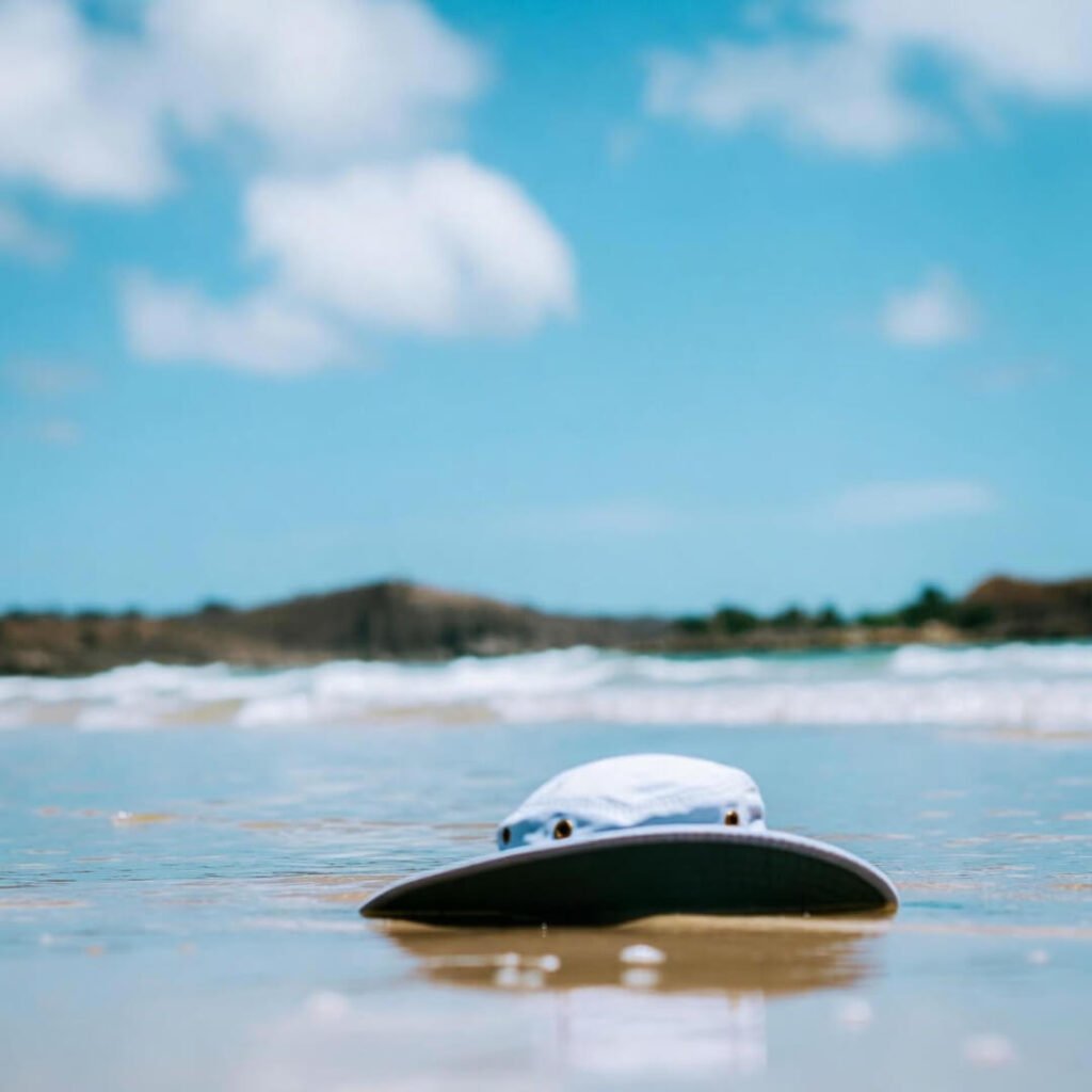 Kid's bucket hat floats half-submerged in Grand Anse waves.