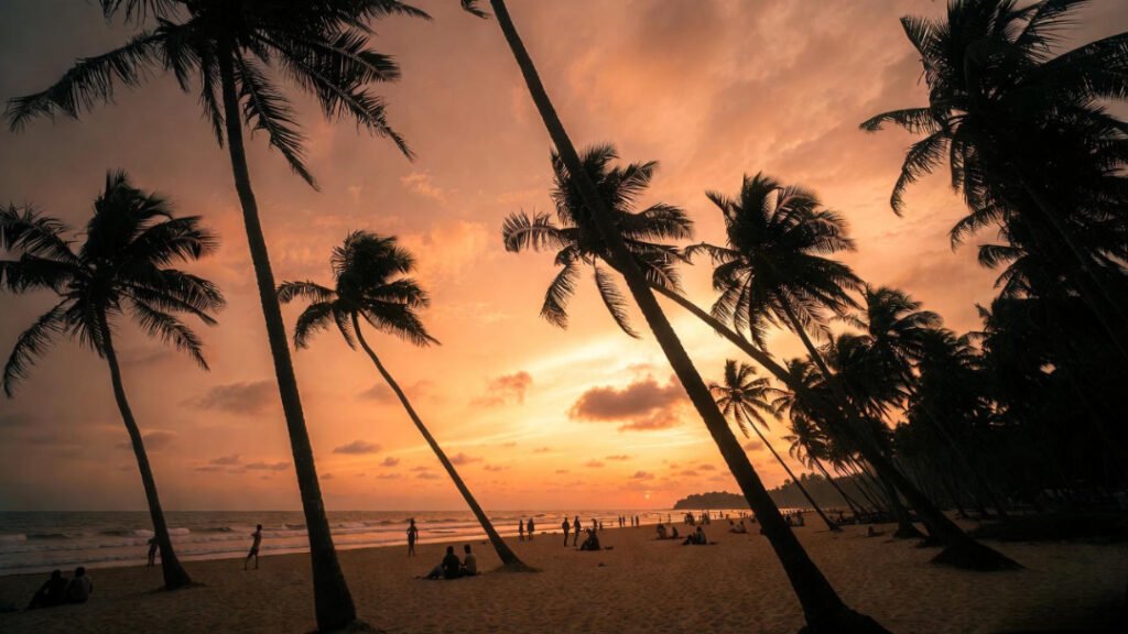 a Goa beach with leaning palm trees, golden-orange sky, silhouettes of people sitting on the sand.