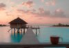Travel to Maldives: Ultimate Guide to Your Dream Island Escape early morning sunrise with soft pink and gold light Unique Elements: