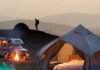 Adventure Awaits: Best Camp Stay Experiences for Every Type of Traveler Cozy glamping bed with sunset view.