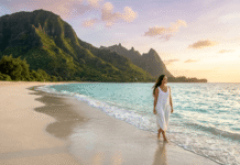 Woman walking on a tropical beach at golden hour.